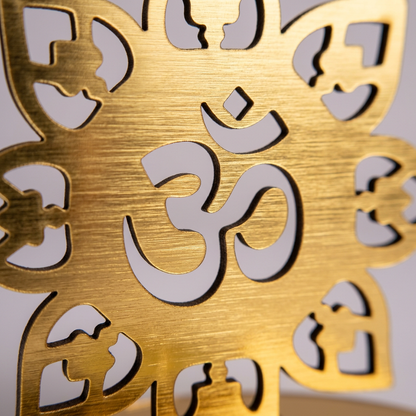 Macro close-up of the golden Om cutout